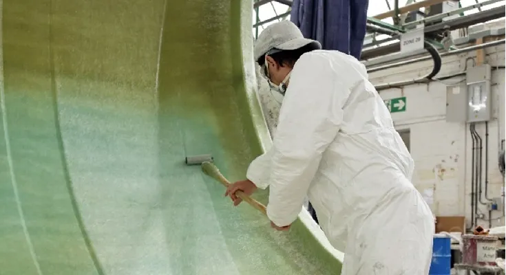 rollering matting into mould during fibreglass lamination process