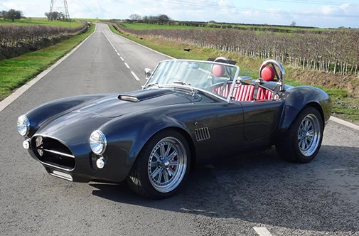 1960s style sportscar with black fibreglass panels made by Quantum